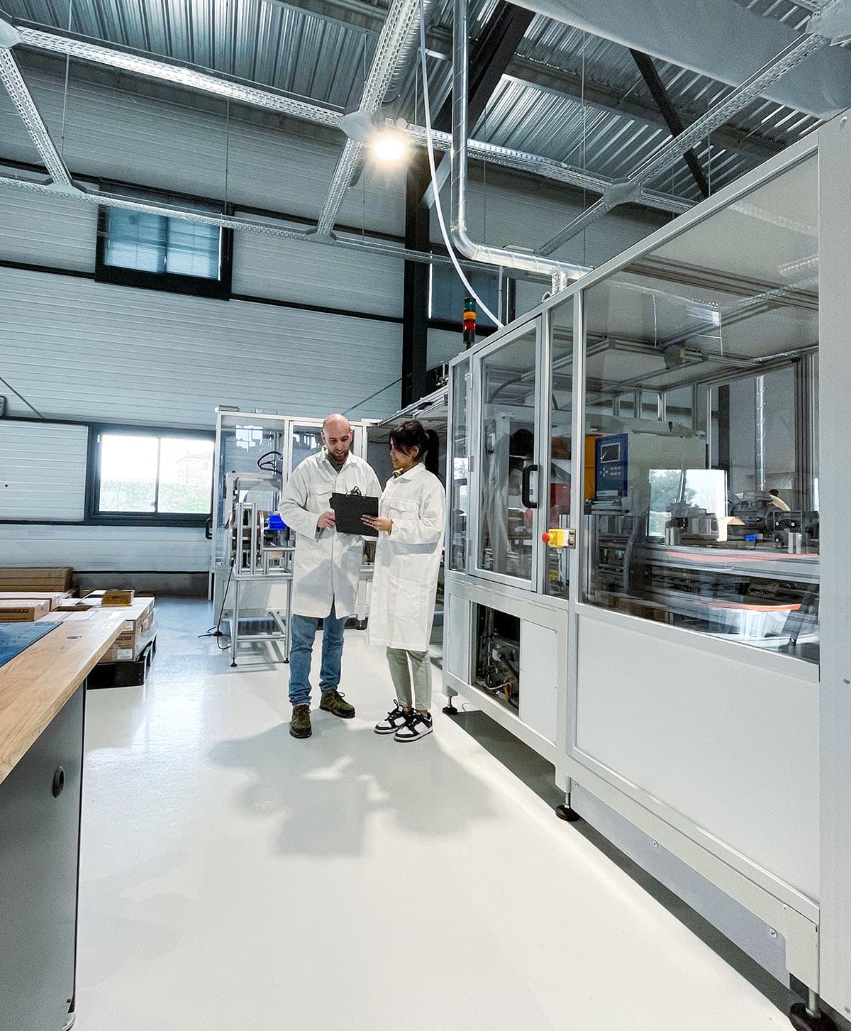 Two Batteries Prod team members reviewing a file in the Monteux workshop